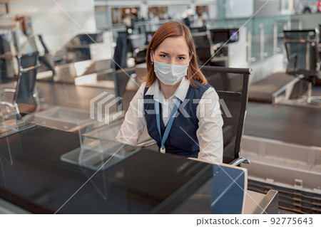Female airport passport control officer at the workplace 92775643