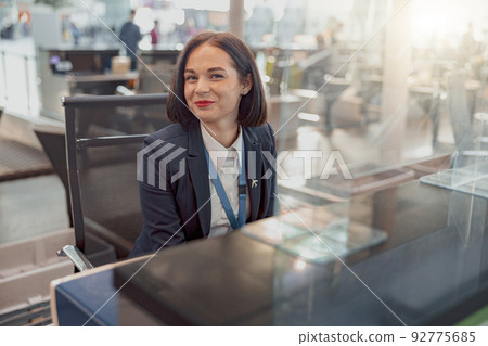 Smiling female employee of the passport control department Smiling female employee of the passport control department 92775685