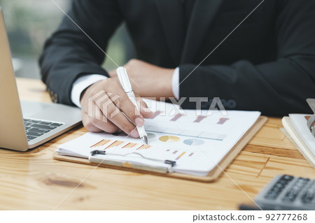 Close up of businessman analyse investment marketing data. Close up of businessman analyse investment marketing data. 92777268