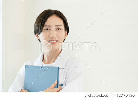 A woman in a white coat A woman in a white coat 92779450