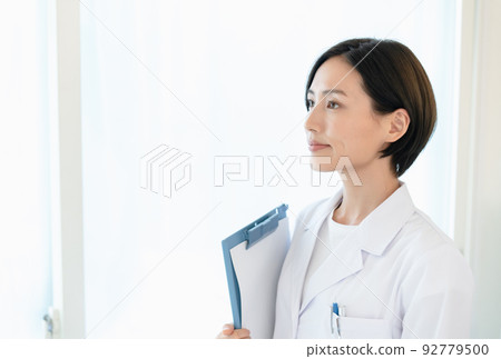A woman in a white coat A woman in a white coat 92779500