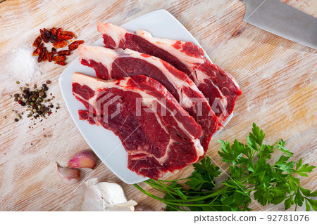 Raw beef fillet with onion and pepper ready for cooking on table Raw beef fillet with onion and pepper ready for cooking on table 92781076