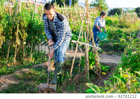 Positive man professional horticulturist with garden shovel at land 92781212