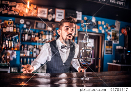 Barman mixes a cocktail on the bar Barman mixes a cocktail on the bar 92781547