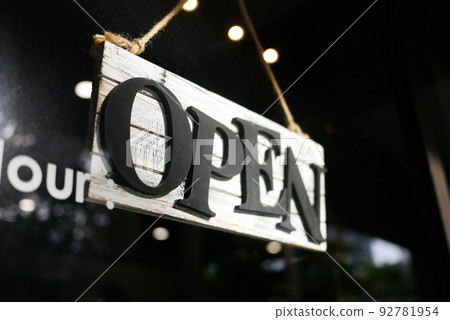 Open sign hanging front of cafe . Open sign hanging front of cafe . 92781954