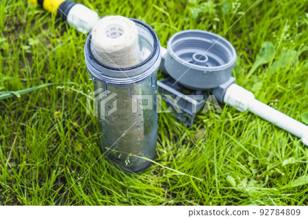 Water filter on green grass Water filter on green grass 92784809