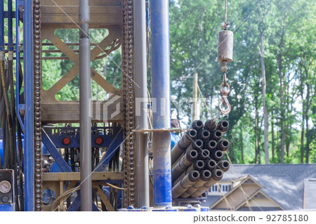 The use of a portable hydraulic water well drilling rig for water extraction on a plot of land is being carried out in the field The use of a portable hydraulic water well drilling rig for water extraction on a plot of land is being carried out in the field 92785180