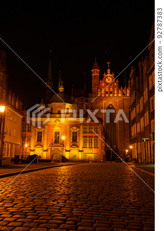 Cityscape of Gdansk with St. Mary Basilica and City Hall at night, Poland. Beautiful architecture of Mariacka street. St. Mary's church in the Old town center. Famous European street in Gdansk 92787383