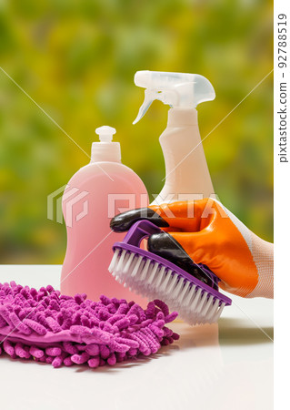 Hand in protective glove with brush on natural background. 92788519