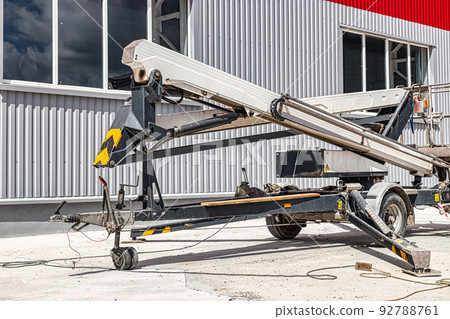 Construction telescopic tower or work platform for people to work at height. Powerful work platform for lifting construction workers up. Construction telescopic tower or work platform for people to work at height. Powerful work platform for lifting construction workers up. 92788761