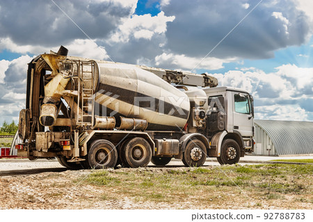 Concrete mixer truck in front of a concrete batching plant, cement factory. Loading concrete mixer truck. Close-up. Delivery of concrete to the construction site. Monolithic concrete works. Concrete mixer truck in front of a concrete batching plant, cement factory. Loading concrete mixer truck. Close-up. Delivery of concrete to the construction site. Monolithic concrete works. 92788783