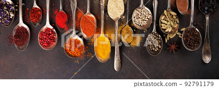 Various spices spoons on stone table Various spices spoons on stone table 92791179