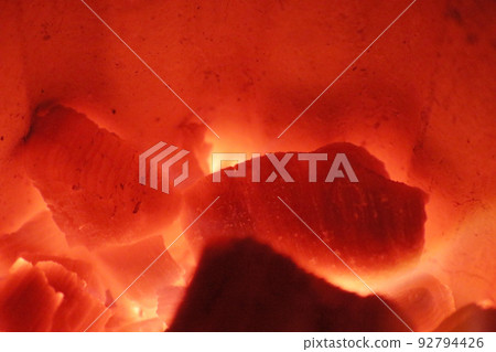 Speaking of winter, it's a hot, piping hot image of a close-up shot of a charcoal fire burning brightly red. Speaking of winter, it's a hot, piping hot image of a close-up shot of a charcoal fire burning brightly red. 92794426