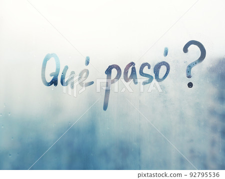Lettering Spanish text question Que paso is What's happened in english on blue wet window 92795536