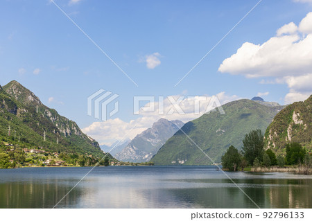 Light summer haze from evaporation over the waters of an alpine lake Idro(Lago d'Idro) 92796133