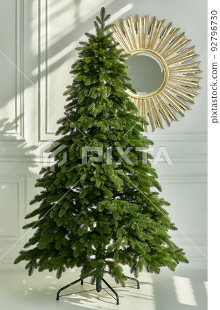 Artificial Christmas green tree without decorations on a metal stand isolated on a white background. Artificial Christmas green tree without decorations on a metal stand isolated on a white background. 92796730