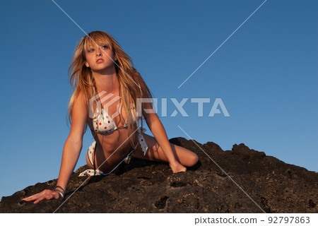 woman enjoying the sunset on the seashore 92797863