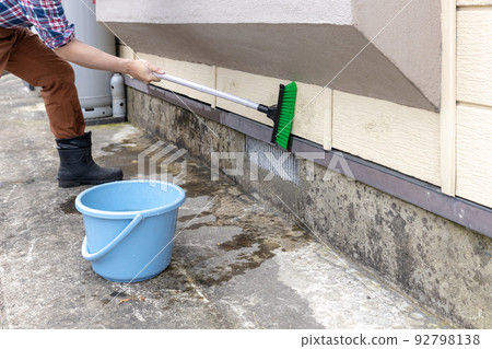 用甲板刷清洗房子的外牆 92798138