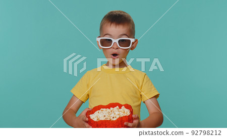 Little cute toddler children boy eating popcorn watching comedy movie film cinema wearing 3D glasses 92798212