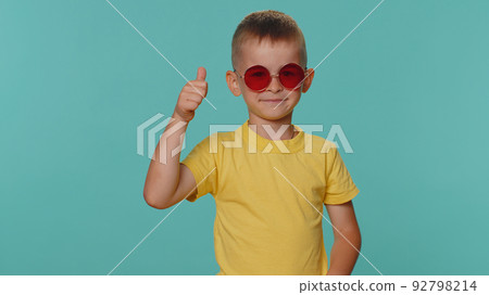Portrait of seductive little toddler children boy in t-shirt wearing red sunglasses, charming smile Portrait of seductive little toddler children boy in t-shirt wearing red sunglasses, charming smile 92798214