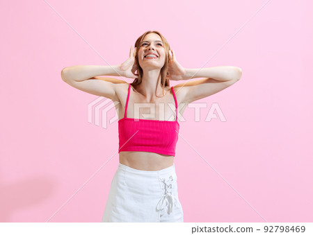 Portrait of young charming girl, student posing isolated on pink background. Concept of beauty, art, fashion, human emotions and facial expressions 92798469