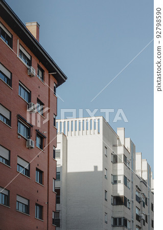 orange and white old house in madrid with strong lights and shadows 92798590