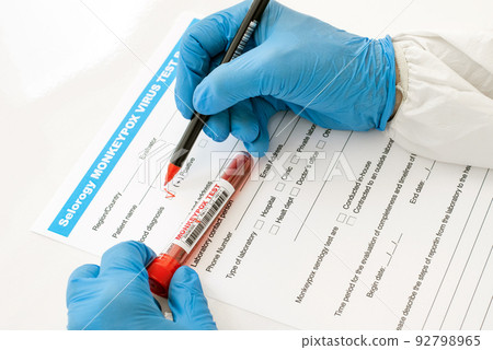 doctor in nitrile gloves fill out blood test form for monkeypox with positive result 92798965
