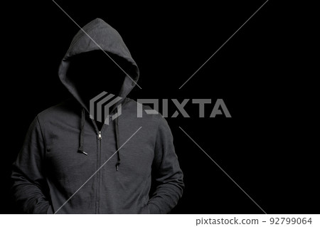 Suspicious person wearing a hood 92799064