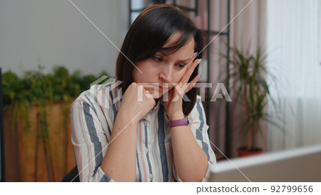 Tired woman teacher using laptop computer suffering from tension, migaine headache at home office 92799656