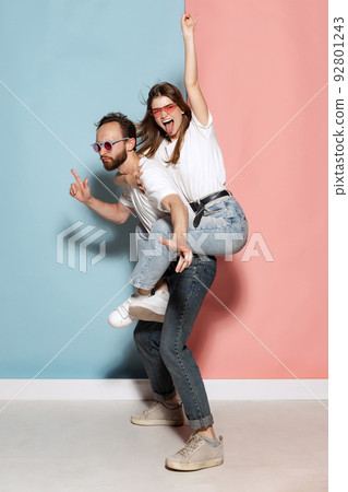 Young crazy man and astonished girl having fun isolated on blue and pink trendy color background. Emotions, youth, love and active lifestyle concept Young crazy man and astonished girl having fun isolated on blue and pink trendy color background. Emotions, youth, love and active lifestyle concept 92801243