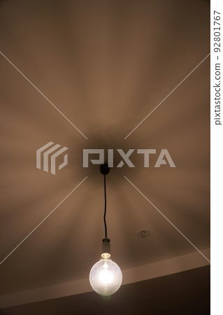 Lights and shadows of a bare light bulb lighting fixture Lights and shadows of a bare light bulb lighting fixture 92801767