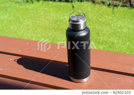 A water bottle on the wooden deck 92802103