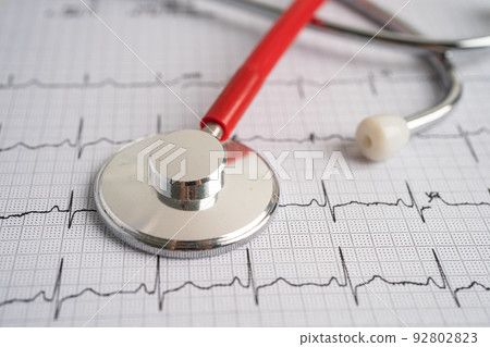 Stethoscope on electrocardiogram (ECG), heart wave, heart attack, cardiogram report. 92802823