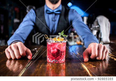 Bartender mixes a cocktail at the beerhouse Bartender mixes a cocktail at the beerhouse 92803103