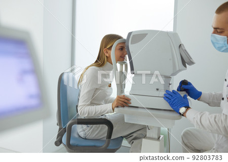 Eye Test. Optometrist Testing Woman Eyesight On Modern Equipment Eye Test. Optometrist Testing Woman Eyesight On Modern Equipment 92803783