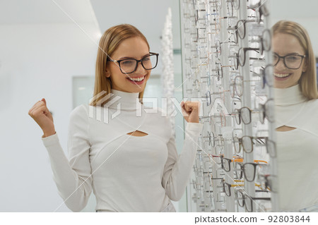 Eyeglasses Store. Woman Choosing Glasses For Eyesight Correction Eyeglasses Store. Woman Choosing Glasses For Eyesight Correction 92803844