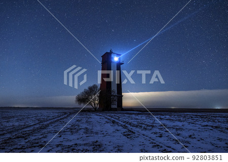 Bright lighthouse beaconing at the end of the milky way. Beautiful lighthouse. 92803851