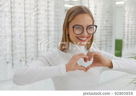 Eyeglasses Store. Woman Posing at Glasses For Eyesight Correction Eyeglasses Store. Woman Posing at Glasses For Eyesight Correction 92803859