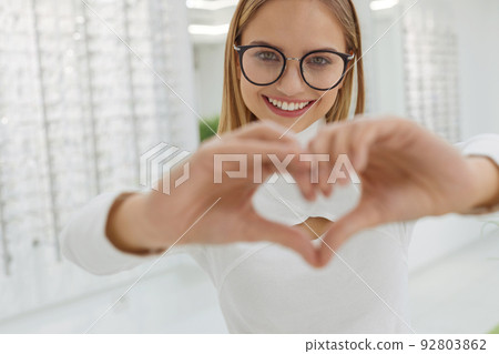 Eyeglasses Store. Woman Posing at Glasses For Eyesight Correction Eyeglasses Store. Woman Posing at Glasses For Eyesight Correction 92803862
