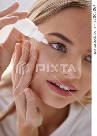 Woman With Eye Drops. Closeup Of Girl Applying Eye Drops In Eyes Woman With Eye Drops. Closeup Of Girl Applying Eye Drops In Eyes 92803864