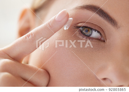 Contact Eye Lens. Cropped of Woman Applying Eye Contacts on her Eyes Contact Eye Lens. Cropped of Woman Applying Eye Contacts on her Eyes 92803865