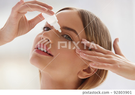 Vision And Ophthalmology Medicine. Beautiful Woman Applying Eyedrops Vision And Ophthalmology Medicine. Beautiful Woman Applying Eyedrops 92803901