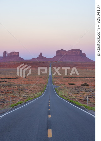 Scenic Road in the Dry Desert with Red Rocky Mountains in Background. Scenic Road in the Dry Desert with Red Rocky Mountains in Background. 92804137