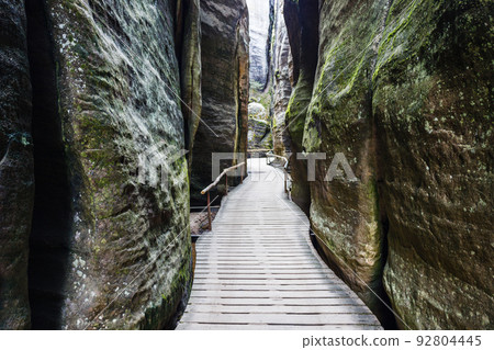 Narrow hiking path between sandstone rock walls at the Adrspach-Teplice Rocks, Czech Republic 92804445