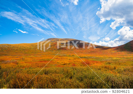 Minimalistic beautiful mountain scenery with golden light on slopes mountains. Scenic mountain landscape with illuminating color in blue sky. 92804621