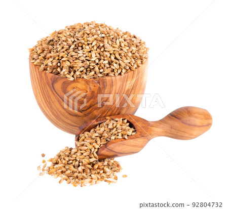 Utsho suneli seeds in wooden bowl and spoon, isolated on white background. Trigonella caerulea or blue fenugreek. Utsho suneli seeds in wooden bowl and spoon, isolated on white background. Trigonella caerulea or blue fenugreek. 92804732