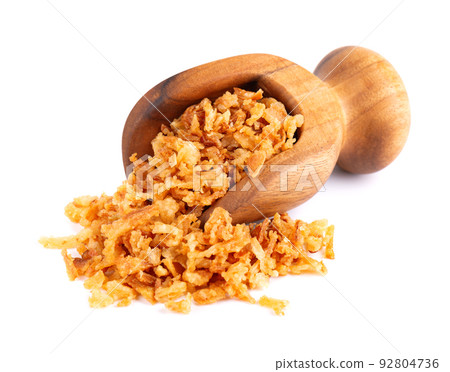 Roasted onions in wooden scoop, isolated on white background. Crispy fried onions. Roasted onions in wooden scoop, isolated on white background. Crispy fried onions. 92804736