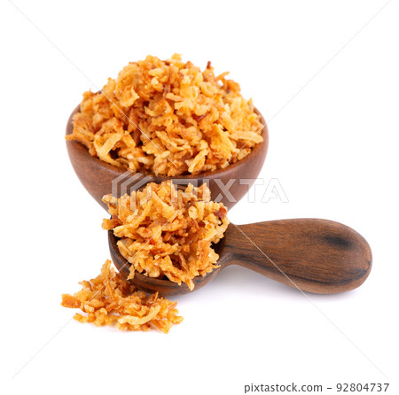 Roasted onions in wooden bowl and spoon, isolated on white background. Crispy fried onions. Roasted onions in wooden bowl and spoon, isolated on white background. Crispy fried onions. 92804737