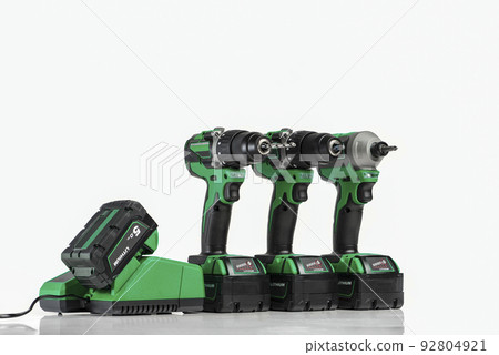 Drill. Set of cordless drills on a white background. Tool for drilling and making holes. Screwdriver set with high capacity spare batteries. 92804921