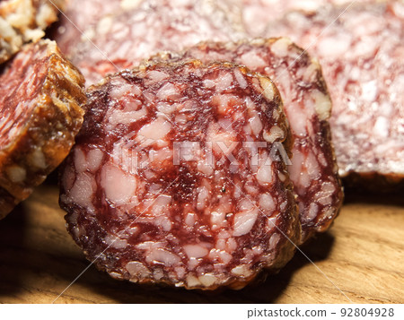 Dried sausage, close-up shot. Lots of sausage slices. 92804928